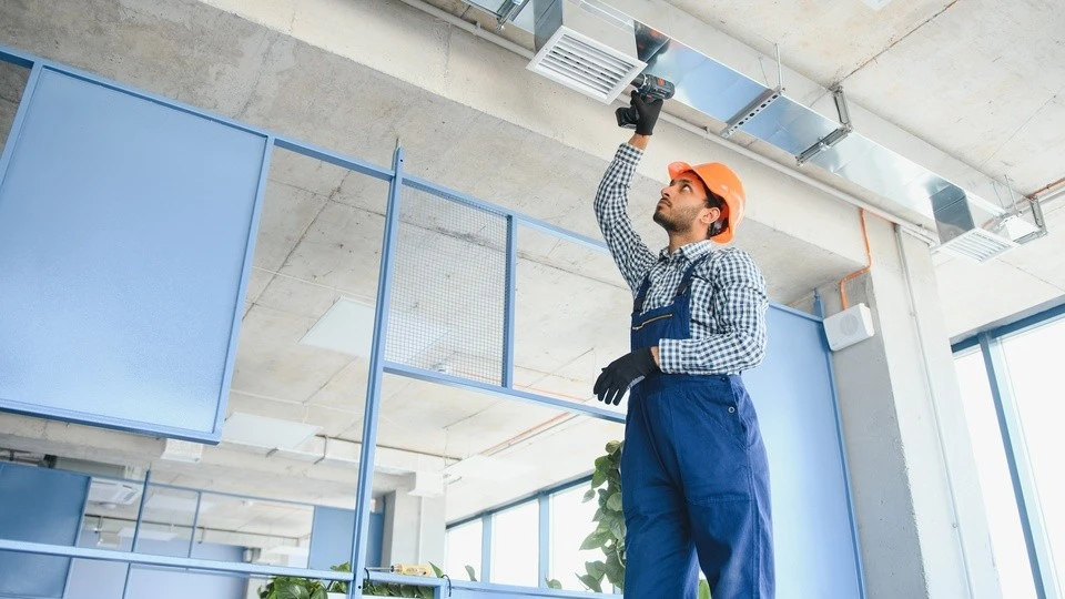 Professional air duct cleaning service being performed in a home